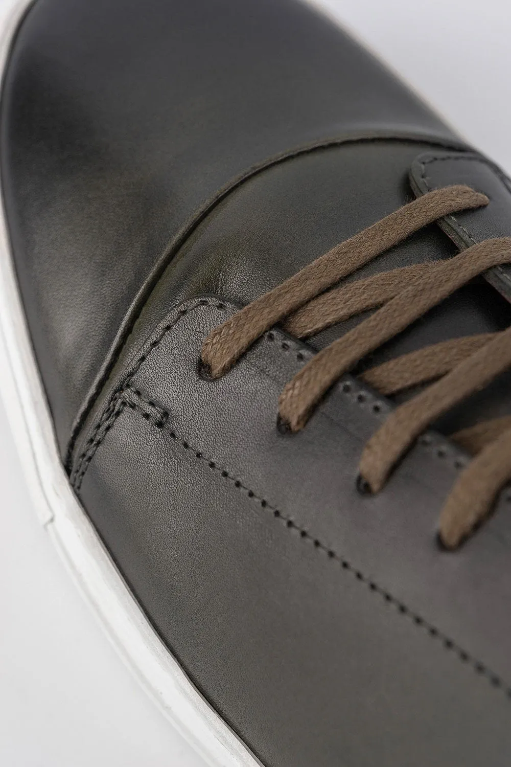 SOHO forest-green cap toe patina sneakers.