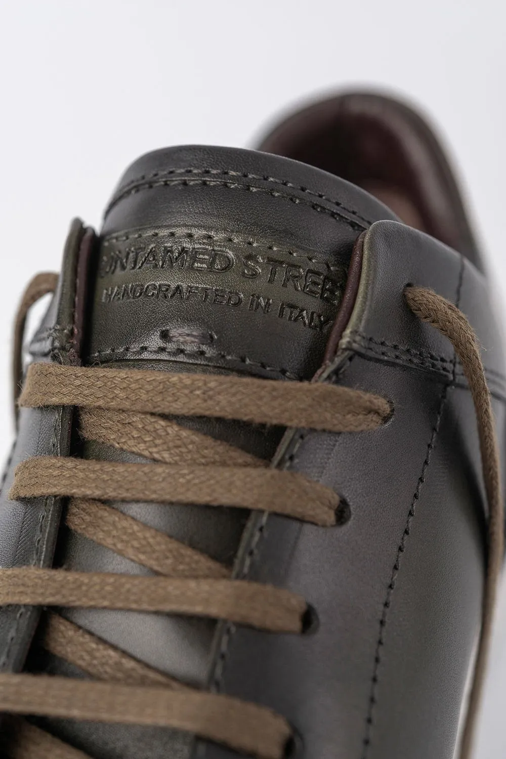 SOHO forest-green cap toe patina sneakers.