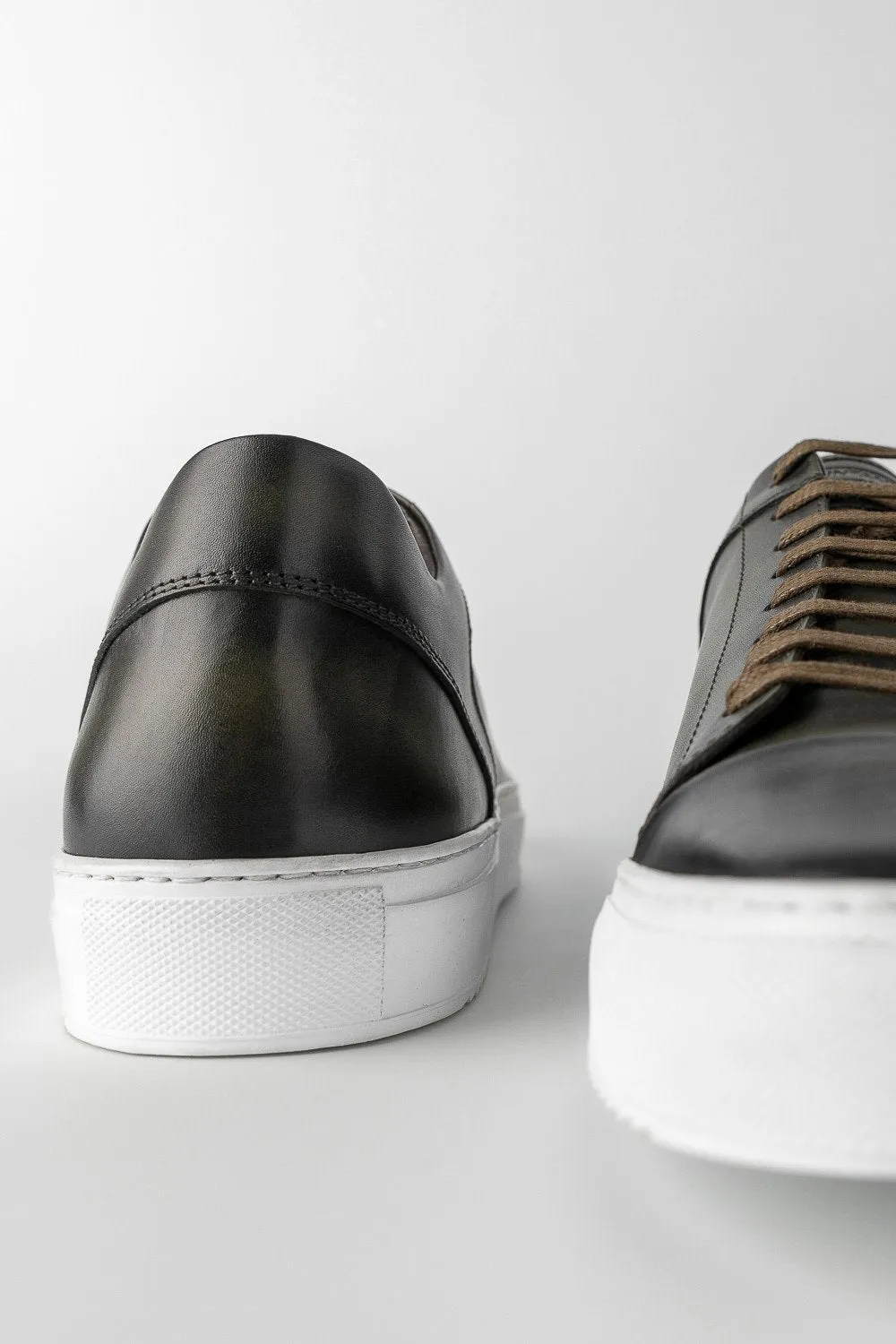 SOHO forest-green cap toe patina sneakers.